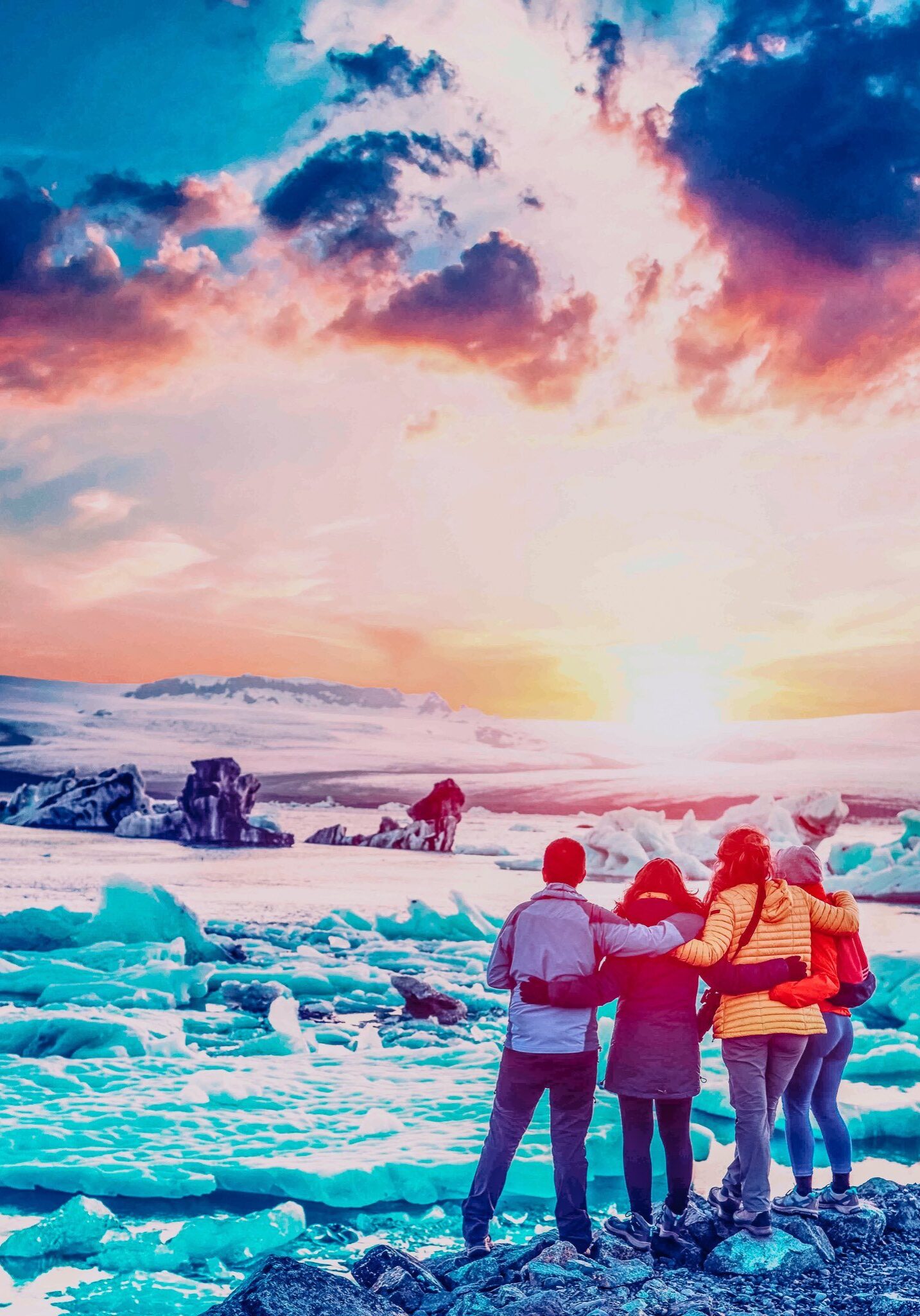 Four friends are looking at the sunset in the famous Jokulsarlon ice lagoon in Iceland. Exotic countries. Amazing places. (memories, impressions, rest, relaxation - concept)
